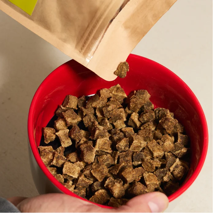 Rocketo being poured from the bag into a red bowl